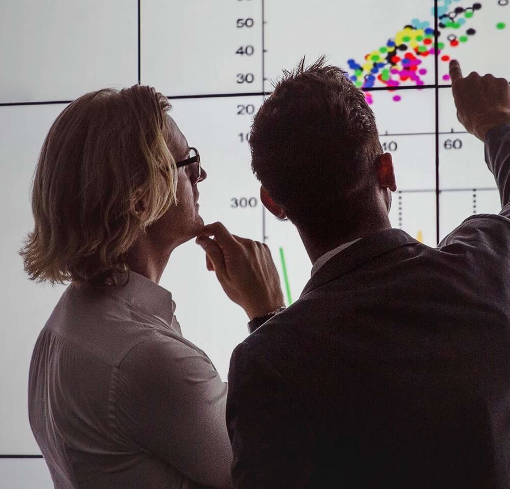 Two people analysing a contract on a large screen with the power of AI.