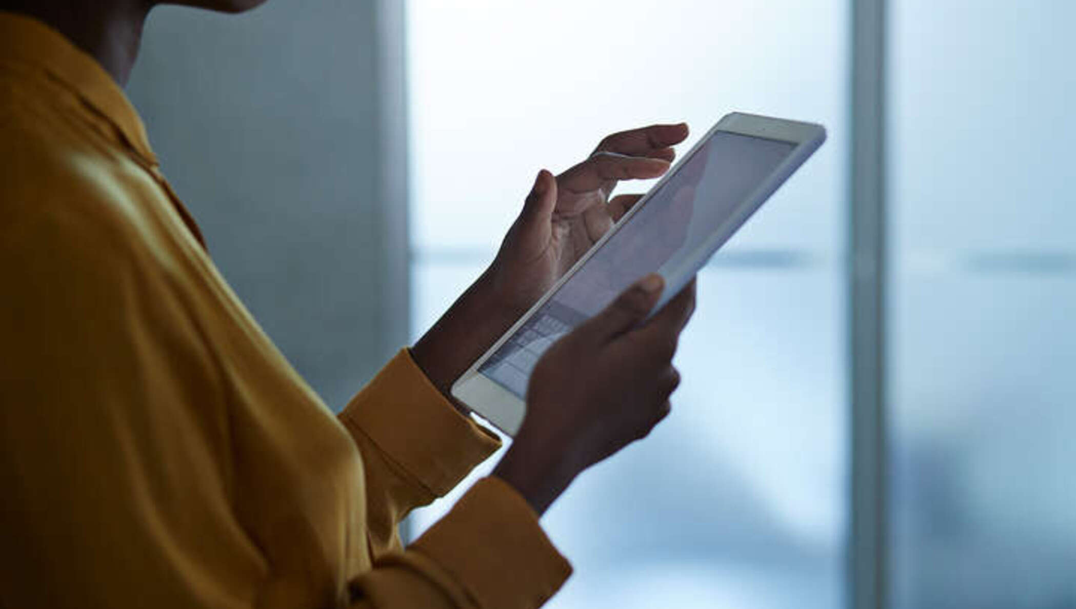Receptionist checking vaccination statuses on a tablet using DocuSign eSignature.